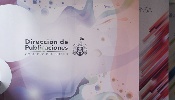 Foto de la entrada de la dirección de Publicaciones, en ella se muestran 3 paneles, el primero muestra el logotipo de la dirección impreso